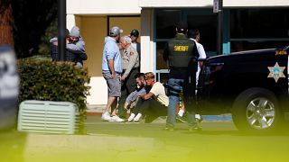 Mourners react outside a reception centre for families of victims of a mass