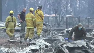 Firefighters work around the clock to dampen down Malibu fires
