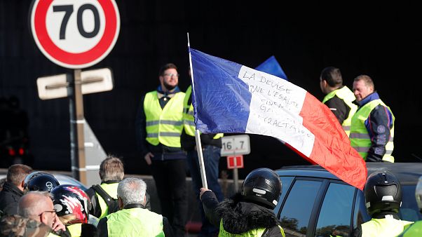 Eine geschwenkte Frankreich-Flagge, Menschen in gelben Warnwesten Eine geschwenkte Frankreich-Flagge, Menschen in gelben Warnwesten