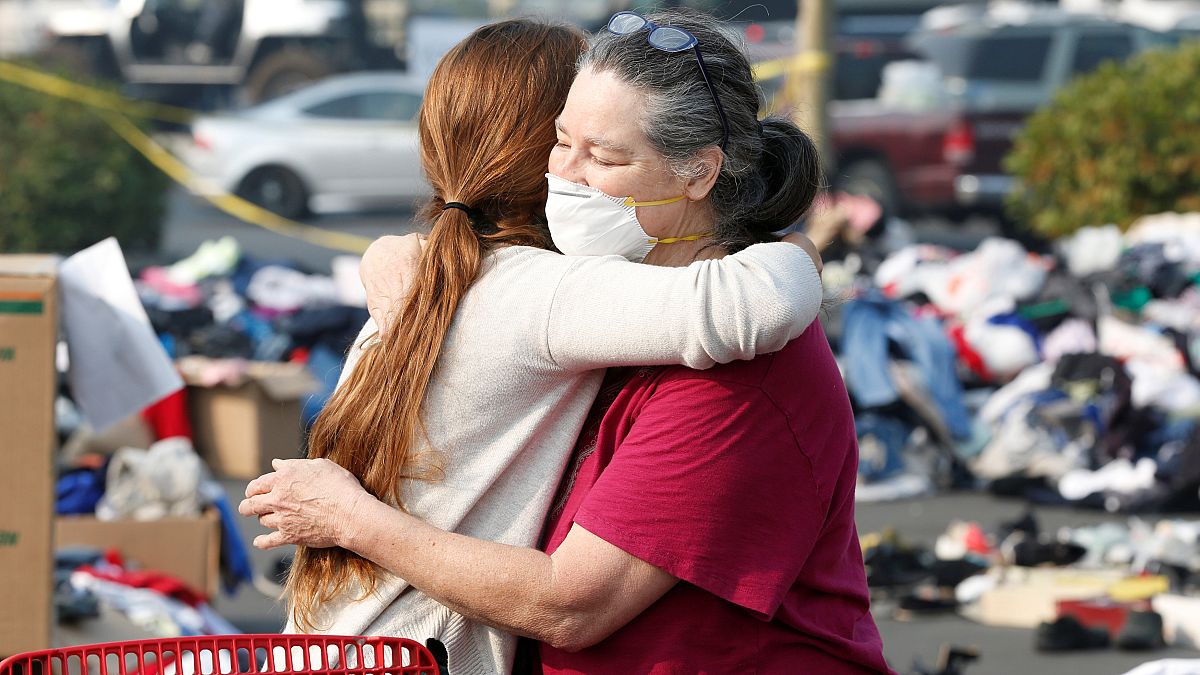 Evacuees from the Camp fire embrace at a makeshift camp in California