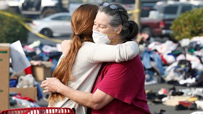 Evacuees from the Camp fire embrace at a makeshift camp in California