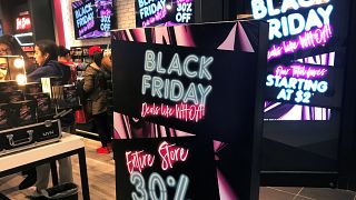 A Black Friday sale sign is displayed outside a makeup store