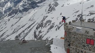 Watch: Freestyle skiers jump roads on Italy's highest mountain pass