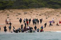 Migrants on Del Canuelo beach, after they crossed the Strait of Gibraltar