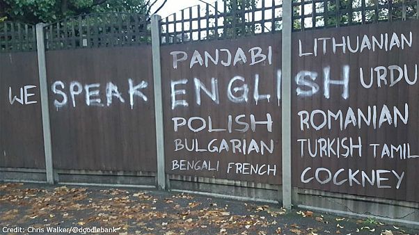 Artist transforms racist graffiti to have positive message Artist transforms racist graffiti to have positive message