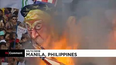 Filipino activists burn effigies of Duterte, Trump and Xi Jinping