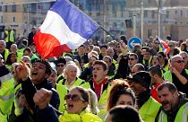People wearing yellow vests, a symbol of a French drivers' protest against