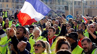 People wearing yellow vests, a symbol of a French drivers' protest against 