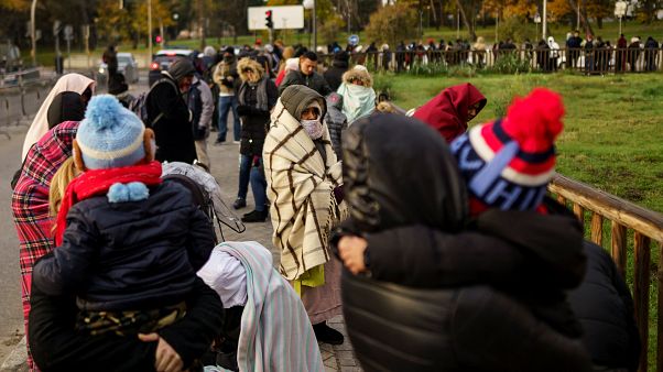 People queue to request asylum outside a Spanish police station on Nov 22 People queue to request asylum outside a Spanish police station on Nov 22