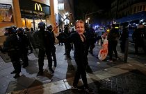 A man dons a Macron mask at a Gilets Jaunes protest in Marseille