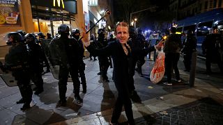 A man dons a Macron mask at a Gilets Jaunes protest in Marseille