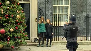 Two women get lots of photos infront of 10 Downing St.