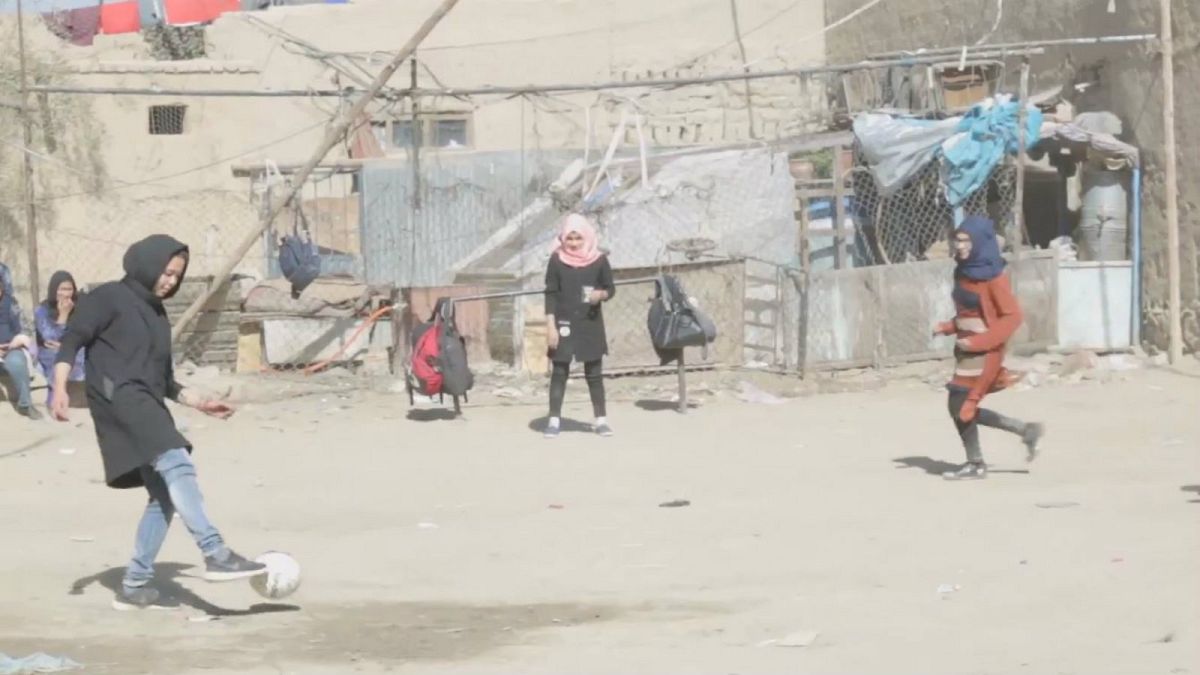 Women play footbal in the streets of Kabul