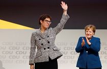 Annegret Kramp-Karrenbauer waves to CDU delegates after her election.