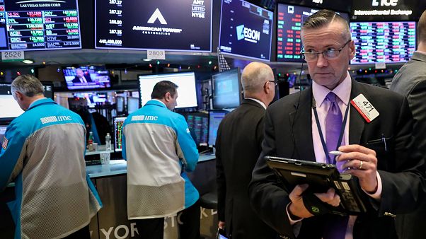 Traders work on the floor of the NYSE in New York Traders work on the floor of the NYSE in New York