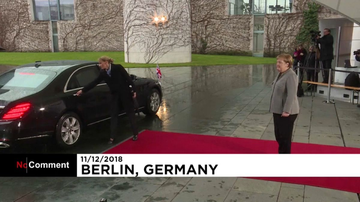 British PM Theresa May locked in car as she meets Angela Merkel