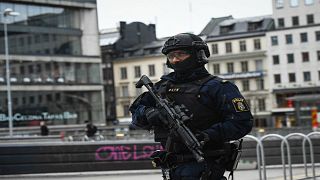 An armed police officer patrols in Stockholm following 2017's attack