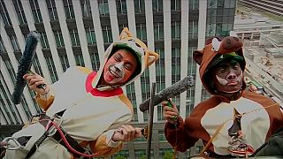 Cleaners dressed as zodiac animals clean hotel windows in Japan