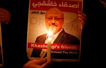 A demonstrator holds a poster with a picture of Saudi journalist Jamal Khas