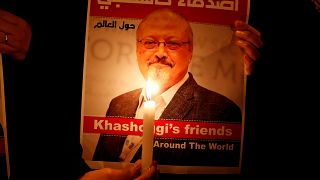 A demonstrator holds a poster with a picture of Saudi journalist Jamal Khas