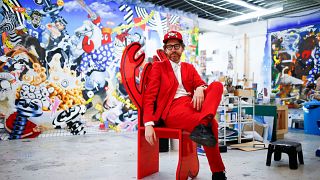 Fashion designer and artist Philip Colbert sits at his studio in Shoreditch