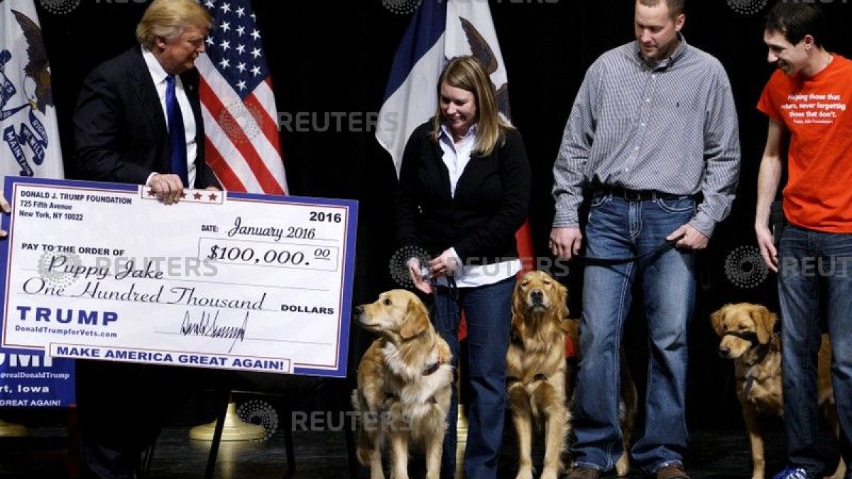 Donald Trump presents a mock check from the Trump Foundation 