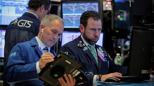 Traders work on the floor of the NYSE in New York Traders work on the floor of the NYSE in New York