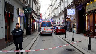 Police officers secure the area next to an ambulance after shots were fired