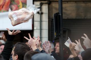 Shoppers bid for cuts of meat during a Christmas Eve auction in London
