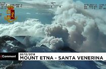 Aerials of Mount Etna erupting and damaged village