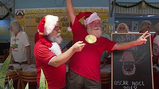 Rio's Santa Claus school graduates celebrate with a beard trim 