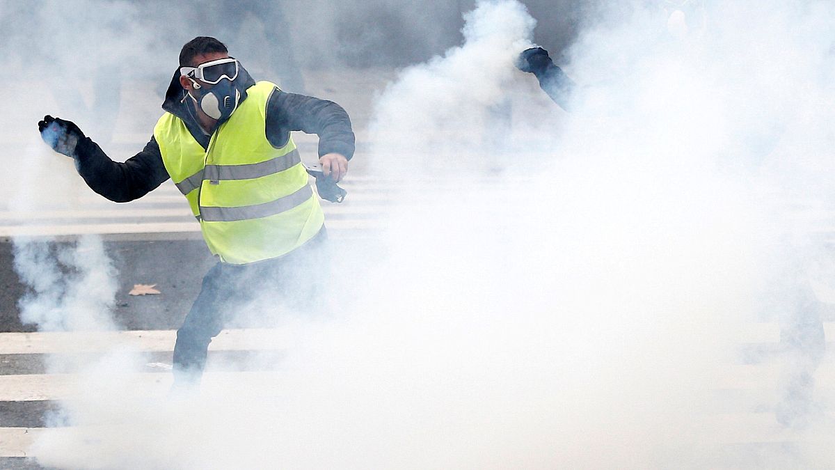 A Yellow vest protester clashes with police in Nantes on Dec 22, 2018.