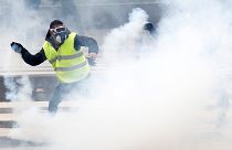 A Yellow vest protester clashes with police in Nantes on Dec 22, 2018.