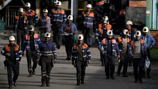 Coal miners leave the mine Pozo Santiago after finishing their shift