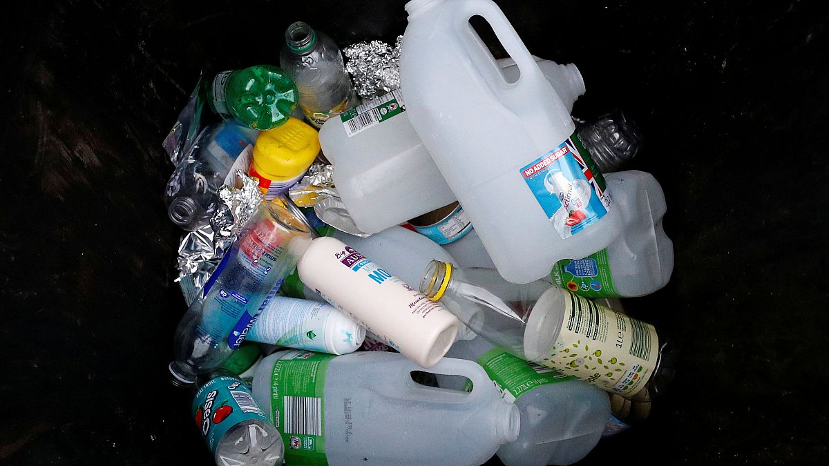 Plastic bottles and containers are seen in a domestic recycling bin