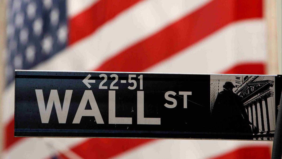A Wall Street sign is seen outside the New York Stock Exchange