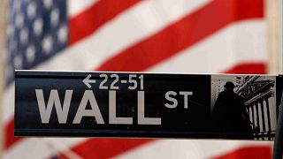 A Wall Street sign is seen outside the New York Stock Exchange