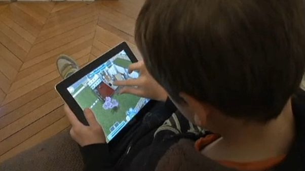 A child watching a screen. A child watching a screen.
