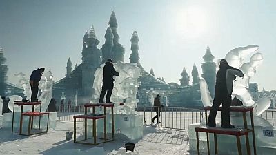 Artists carve icy masterpieces for contest at Harbin ice festival