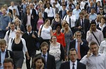 Commuters walk across London Bridge to the City of London August 7, 2013.