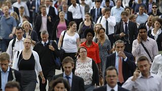 Commuters walk across London Bridge to the City of London August 7, 2013. 