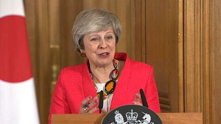 UK PM May speaking at a press conference alongside Japanese counterpart Abe