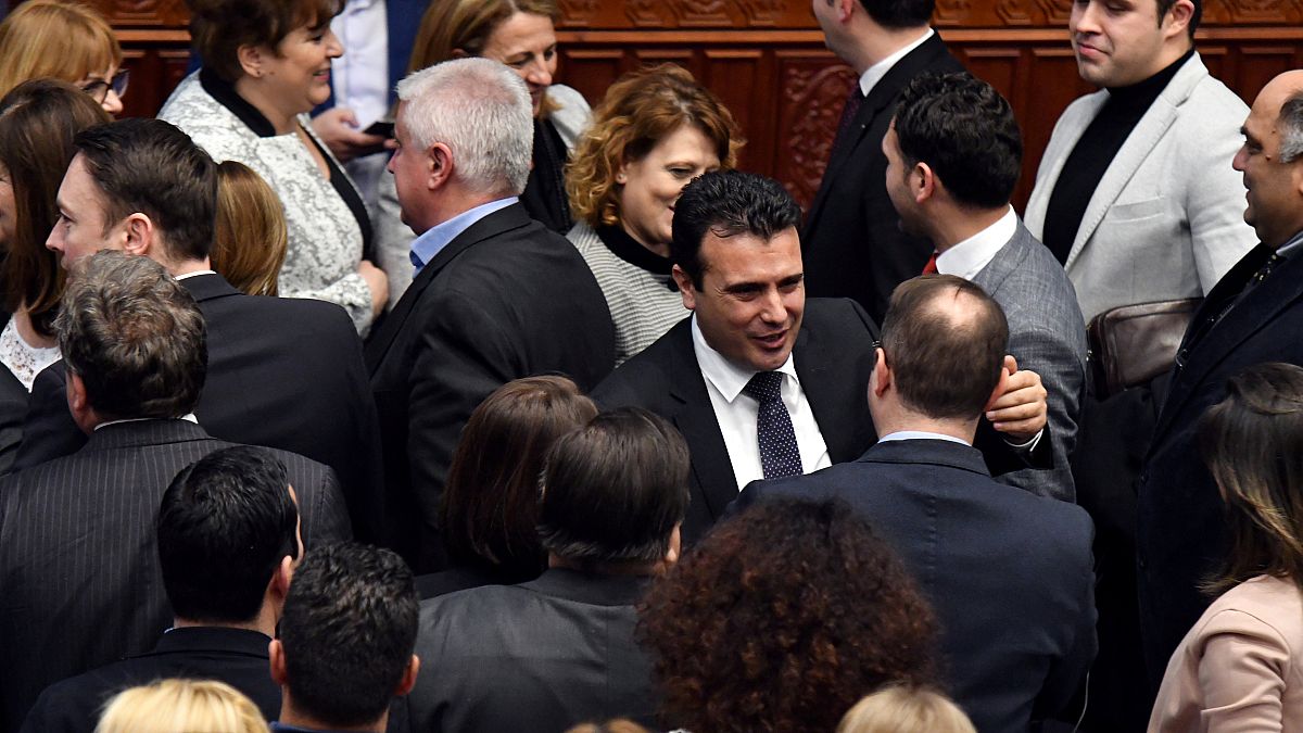 Prime Minister Zoran Zaev greets MPs after the vote.