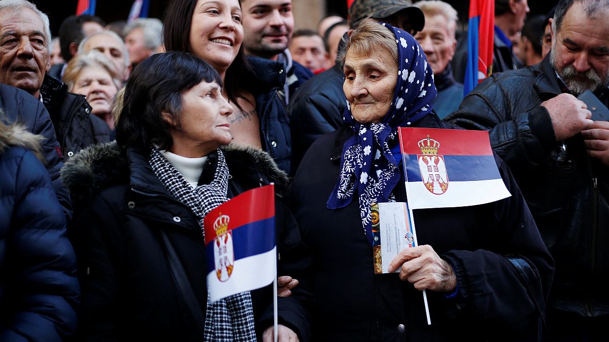 Thousands gather in Belgrade to cheer Putin during his brief visit to Serbia