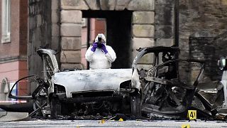 A forensic officer at the scene of a suspected car bomb in Londonderry.