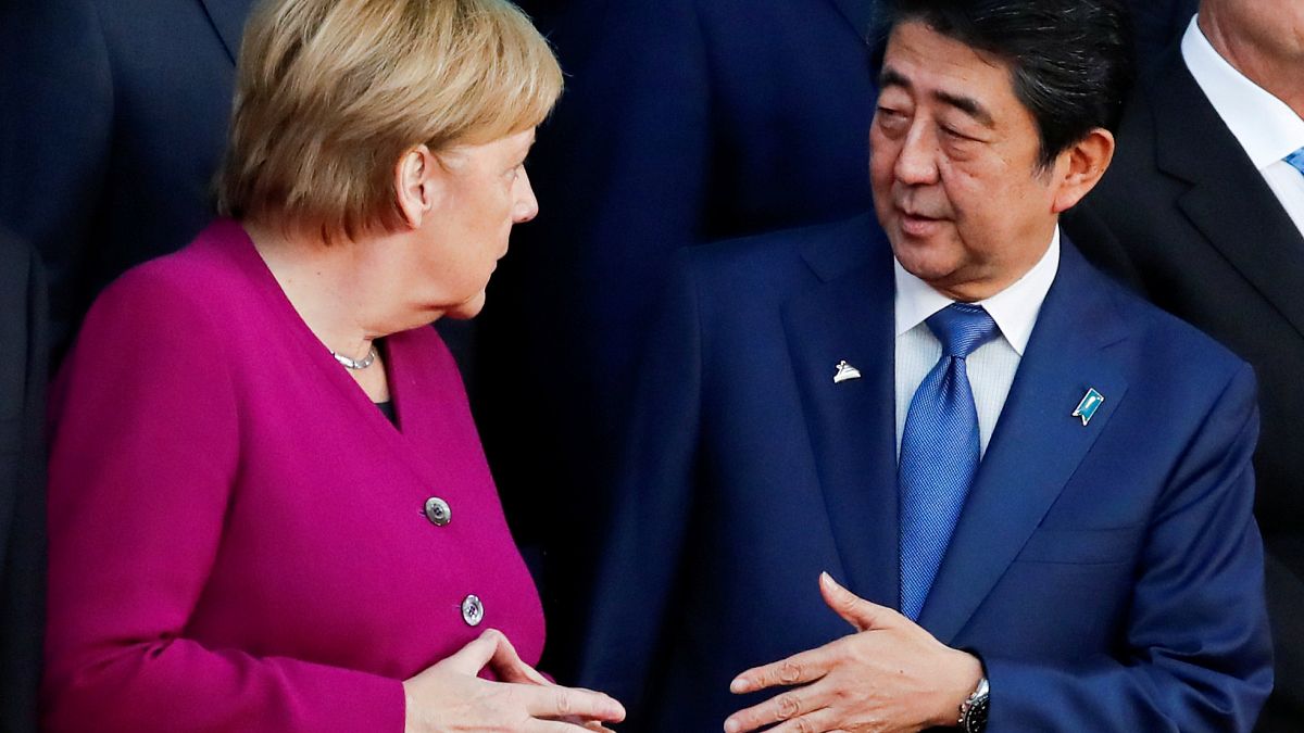 German Chancellor Angela Merkel and Japan's Prime Minister Shinzo Abe talk 