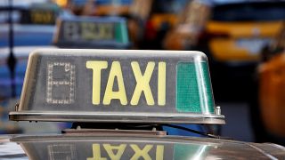 A taxi is pictured in Barcelona during a protest against ride-hailing apps.