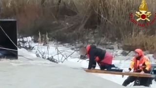 Watch: Italian firefighters use planks of wood to rescue group from flooded river