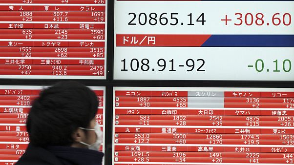 Japan's Nikkei 225 index at a securities firm in Tokyo Japan's Nikkei 225 index at a securities firm in Tokyo