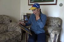 Nelly Pompa cries as she looks at a picture of her son Miguel